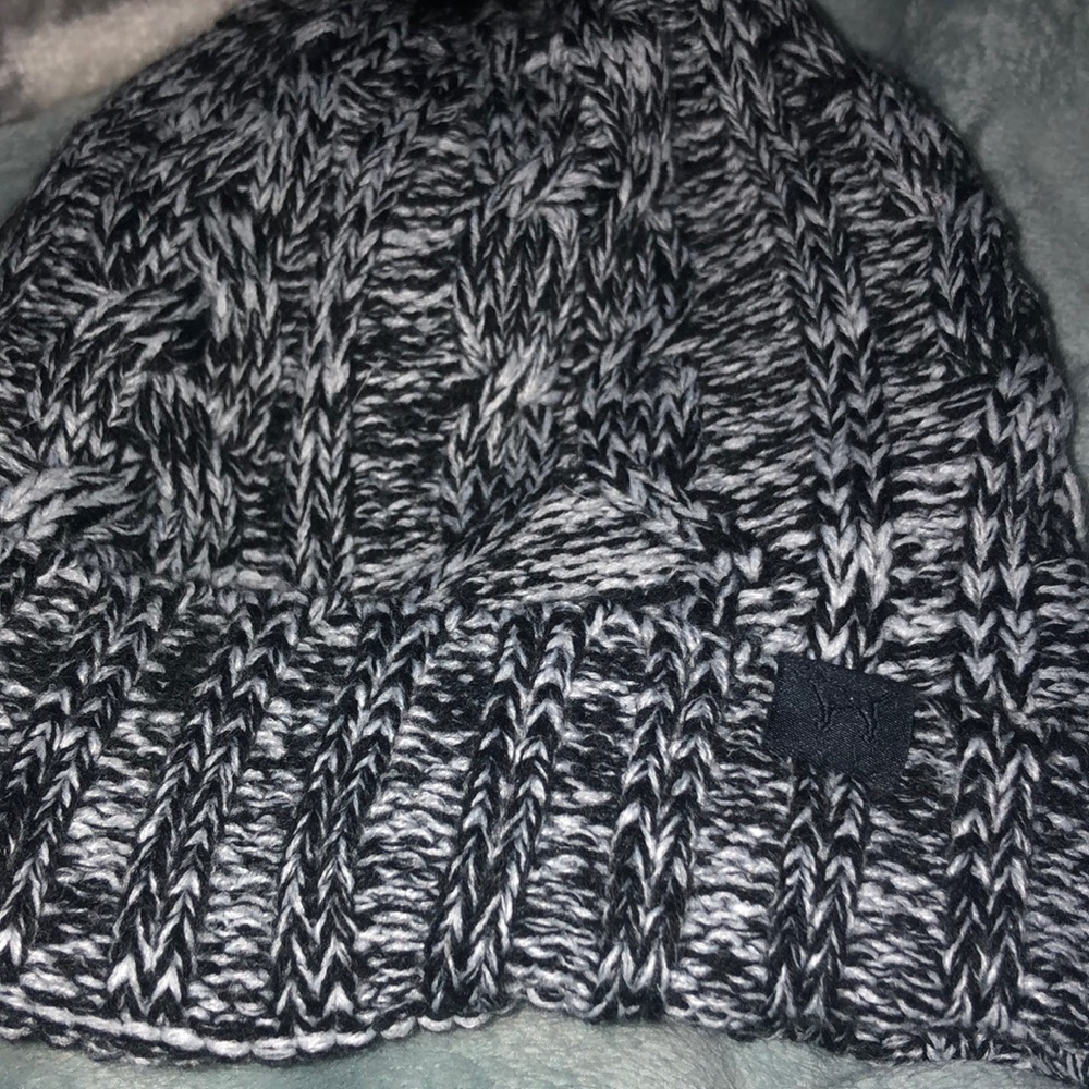 A BLACK AND WHITE HAT FROM PINK